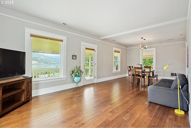1006 4th Ave, Mosier, OR 97040 - living area with wood finished floors, baseboards, and a chandelier
