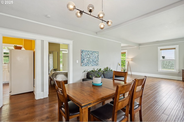 1006 4th Ave, Mosier, OR 97040 - dining space with dark wood-type flooring, a chandelier, beamed ceiling, and baseboards