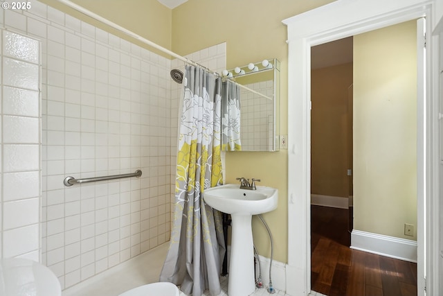 1006 4th Ave, Mosier, OR 97040 - bathroom with a tile shower, wood finished floors, a sink, and toilet
