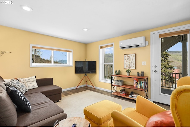 1006 4th Ave, Mosier, OR 97040 - living room with an AC wall unit, healthy amount of natural light, wood finished floors, baseboards, and recessed lighting