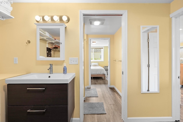 1006 4th Ave, Mosier, OR 97040 - bathroom featuring wood finished floors, vanity, and baseboards