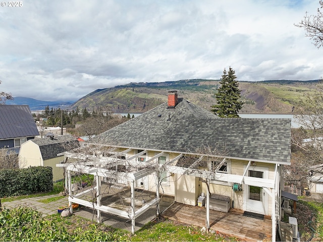 1006 4th Ave, Mosier, OR 97040 - back of property with a shingled roof, a chimney, and a deck with mountain view