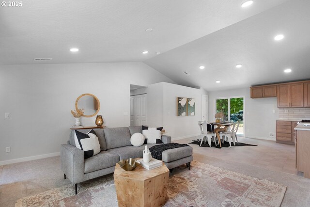 carpeted living room featuring lofted ceiling