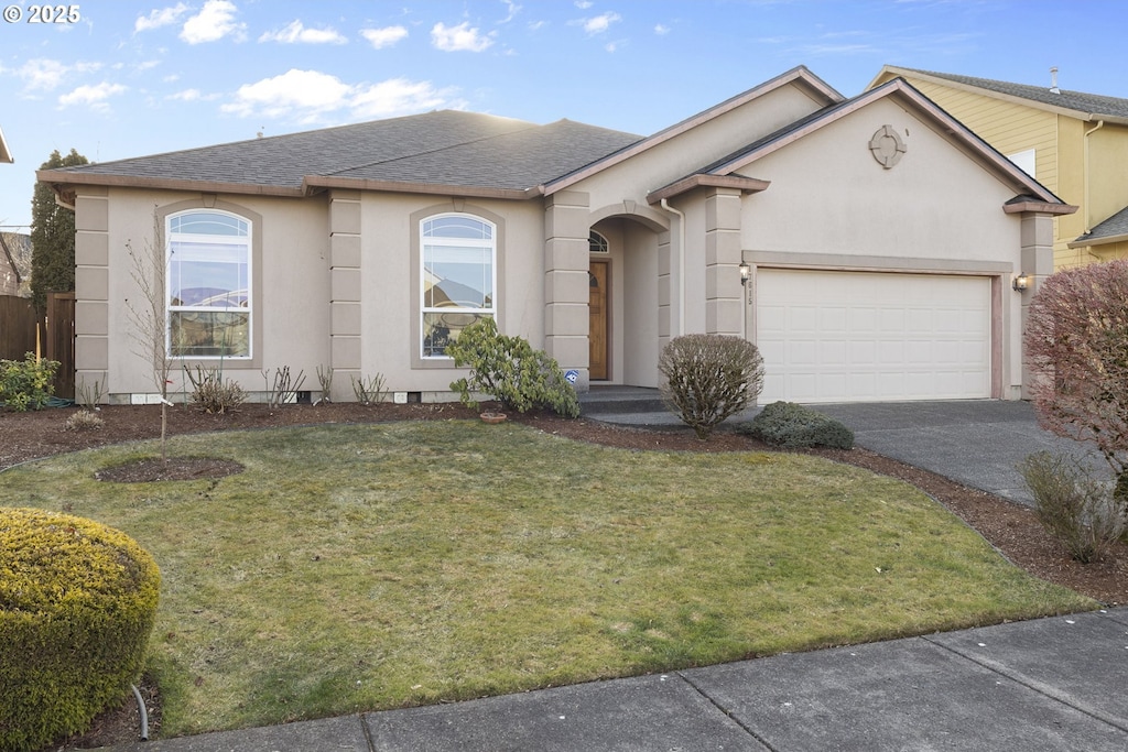 single story home with a garage and a front yard