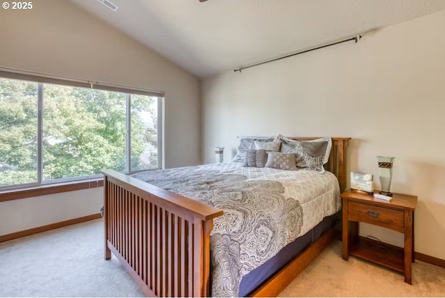 bedroom with vaulted ceiling and light carpet