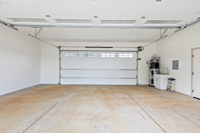 garage featuring electric panel and water heater