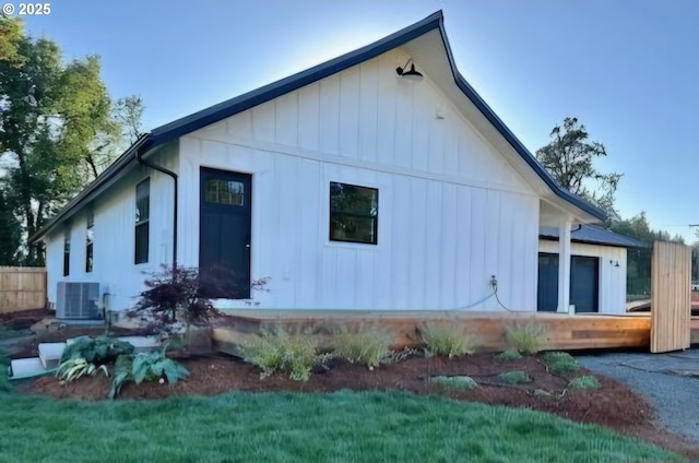 view of side of property with central AC and a deck