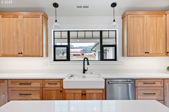 kitchen with sink, decorative light fixtures, light brown cabinetry, and dishwasher