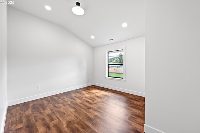 unfurnished room with vaulted ceiling and dark hardwood / wood-style floors