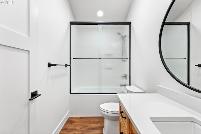 full bathroom with vanity, toilet, combined bath / shower with glass door, and wood-type flooring