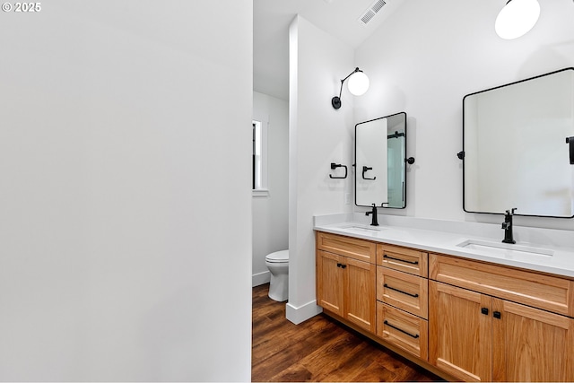 bathroom featuring hardwood / wood-style floors, toilet, and vanity