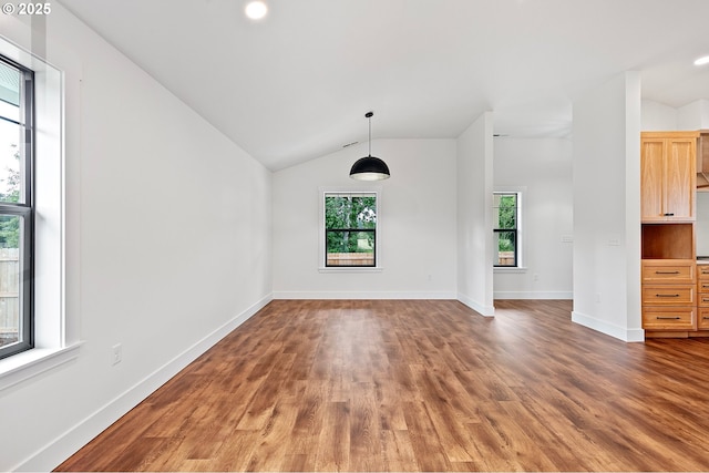 unfurnished room with dark wood-type flooring and vaulted ceiling