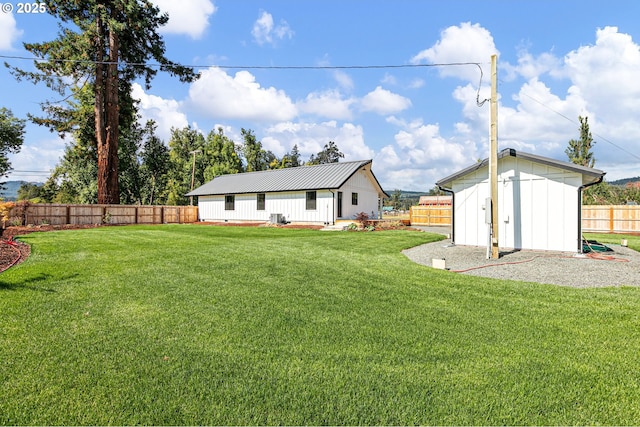 view of yard featuring central air condition unit and a shed