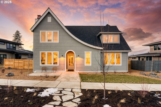 view of front of property featuring a lawn and a patio