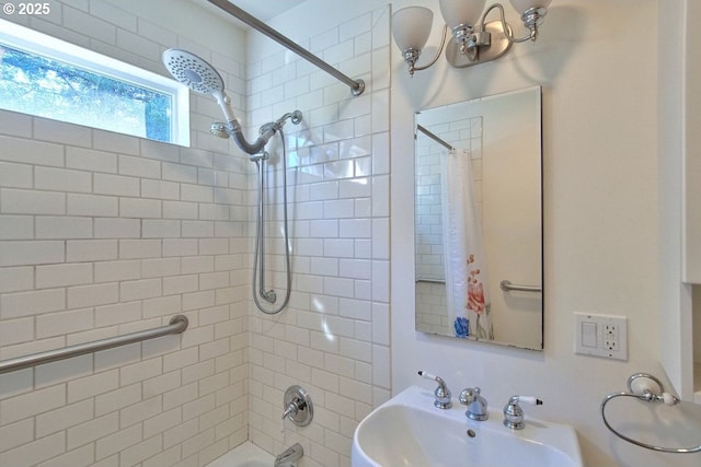 bathroom with tiled shower / bath combo and sink