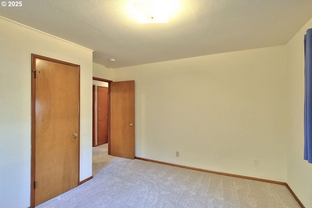 unfurnished bedroom featuring light carpet and a closet