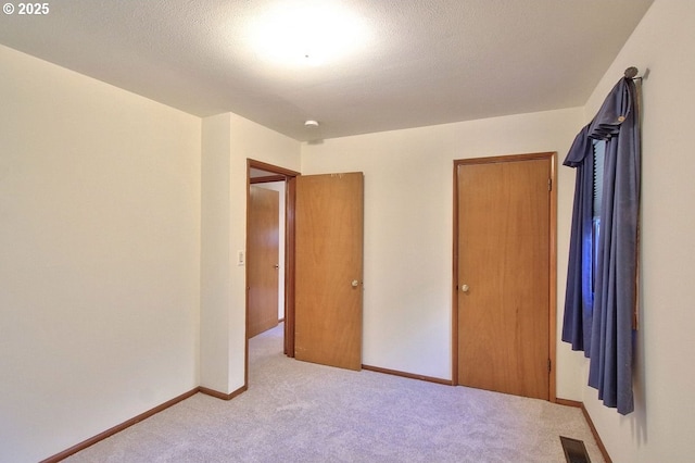 unfurnished bedroom with light carpet