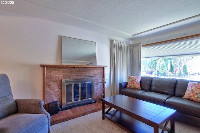 carpeted living room with a textured ceiling and a brick fireplace