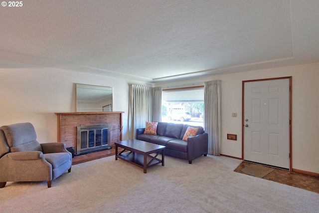 living room with light carpet, a textured ceiling, and a brick fireplace