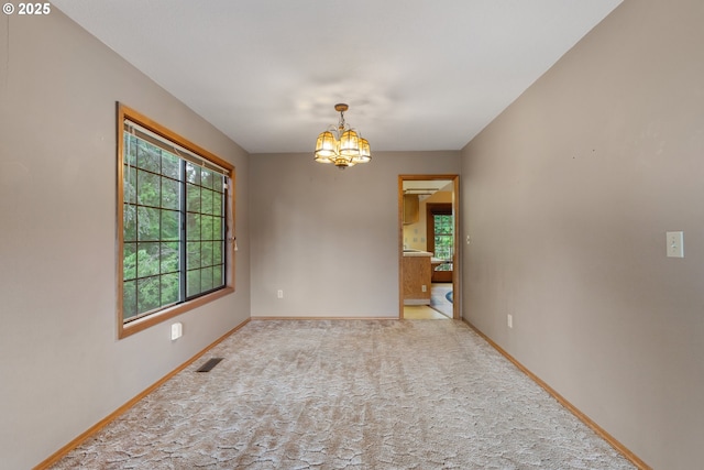 1705 SW 24th Dr, Gresham, OR 97080 - empty room featuring a chandelier, plenty of natural light, baseboards, and light carpet