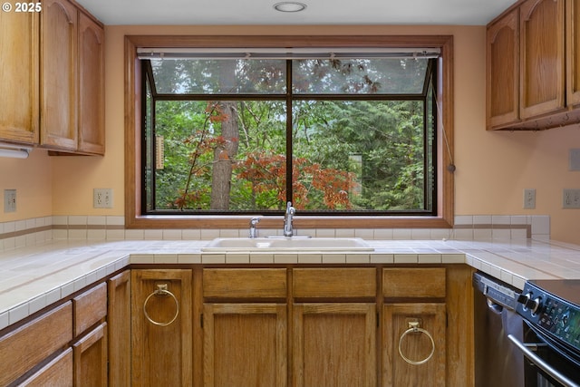 1705 SW 24th Dr, Gresham, OR 97080 - kitchen featuring a sink, appliances with stainless steel finishes, and brown cabinets