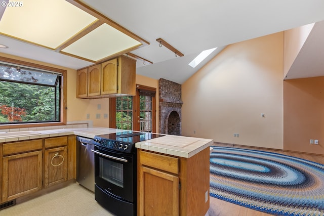 1705 SW 24th Dr, Gresham, OR 97080 - kitchen featuring black range with electric stovetop, a peninsula, dishwasher, a skylight, and vaulted ceiling