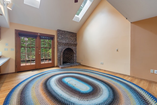 1705 SW 24th Dr, Gresham, OR 97080 - unfurnished living room with wood finished floors, a skylight, french doors, high vaulted ceiling, and a large fireplace