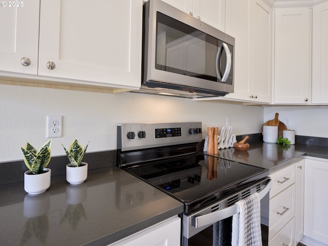 521 Kakela Rd, Winlock, WA 98596 - kitchen with appliances with stainless steel finishes, white cabinets, and dark countertops