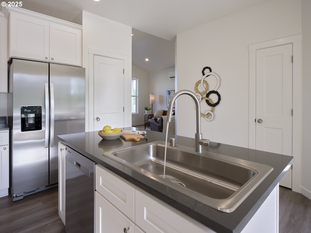 521 Kakela Rd, Winlock, WA 98596 - kitchen with stainless steel appliances, dark countertops, a sink, dark wood finished floors, and white cabinets