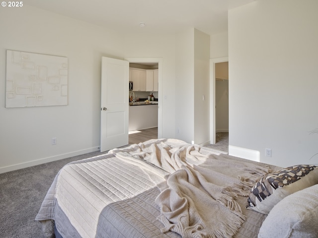521 Kakela Rd, Winlock, WA 98596 - bedroom featuring a spacious closet, carpet floors, a closet, baseboards, and a sink