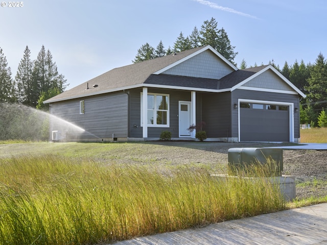521 Kakela Rd, Winlock, WA 98596 - view of front facade featuring a garage, driveway, and roof with shingles