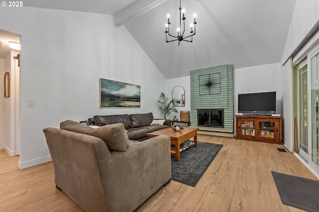 living room with a fireplace, beamed ceiling, high vaulted ceiling, light wood-type flooring, and a notable chandelier