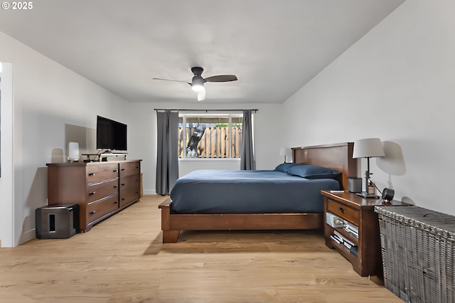 bedroom with ceiling fan, baseboards, and light wood-style floors