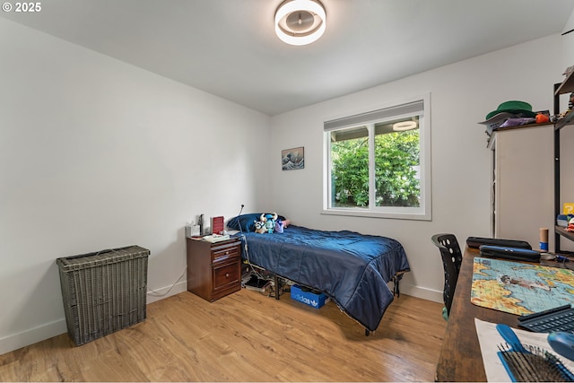 bedroom featuring baseboards and light wood-style flooring