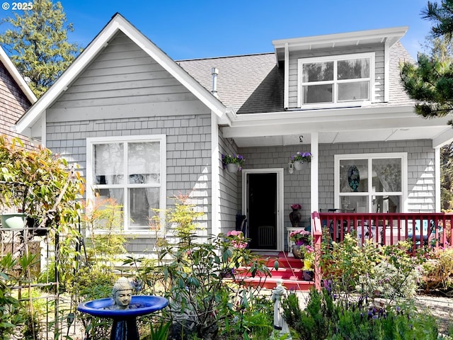bungalow-style house with covered porch and a shingled roof