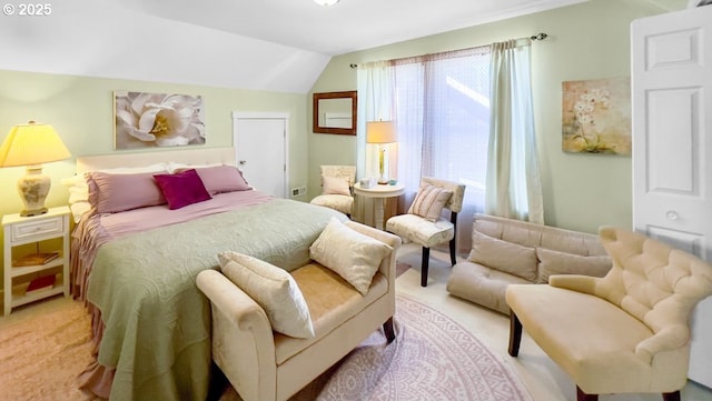 bedroom featuring light carpet and lofted ceiling