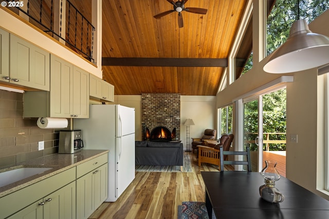 25050 Wilson River Hwy, Tillamook, OR 97141 - kitchen featuring freestanding refrigerator, light wood-style floors, ceiling fan, decorative backsplash, and stone counters