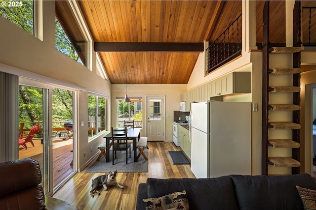 25050 Wilson River Hwy, Tillamook, OR 97141 - sunroom with high vaulted ceiling, plenty of natural light, wood ceiling with exposed beams, hardwood / wood-style flooring, and baseboards