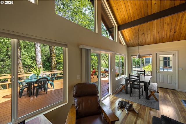 25050 Wilson River Hwy, Tillamook, OR 97141 - sunroom with plenty of natural light, a wooden deck, high vaulted ceiling, wood finished floors, and wooden ceiling with exposed beams