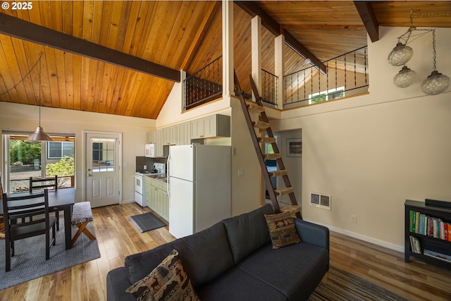 25050 Wilson River Hwy, Tillamook, OR 97141 - living room with stairs, wood ceiling with exposed beams, light wood-style flooring, baseboards, and high vaulted ceiling