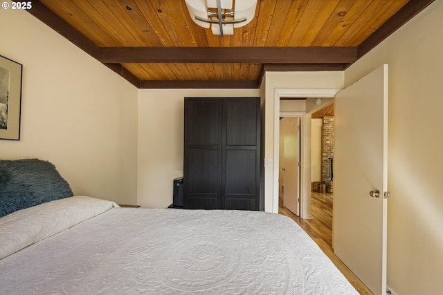25050 Wilson River Hwy, Tillamook, OR 97141 - bedroom with wood ceiling with exposed beams, wood finished floors, and a chandelier