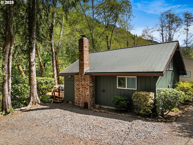 25050 Wilson River Hwy, Tillamook, OR 97141 - view of front of house featuring a chimney and metal roof