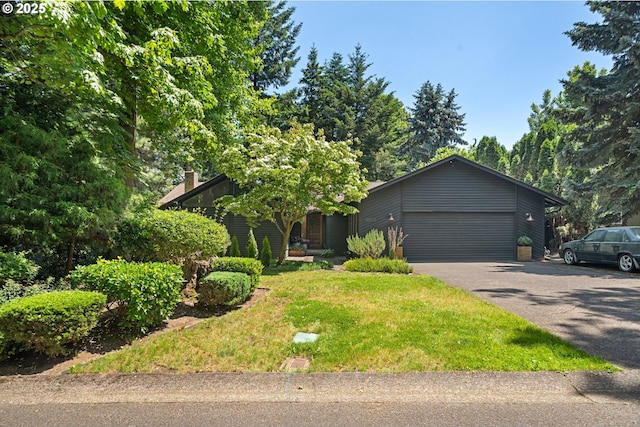 16523 NE Fargo Cir, Portland, OR 97230 - obstructed view of property with an attached garage, asphalt driveway, and a front yard