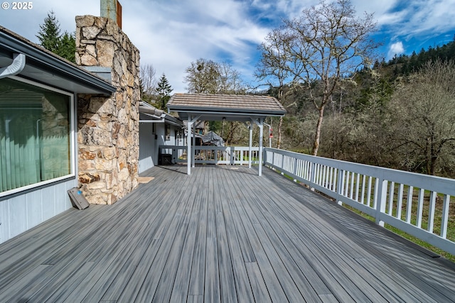 wooden terrace featuring a gazebo