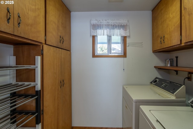 laundry area with cabinet space and independent washer and dryer