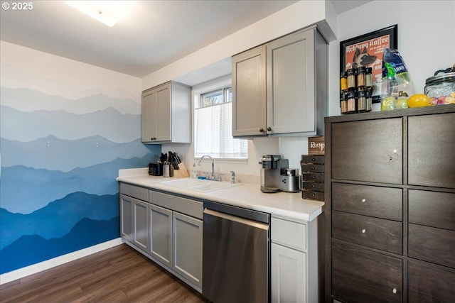 kitchen with stainless steel dishwasher, dark hardwood / wood-style floors, sink, and gray cabinetry