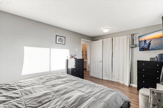 bedroom with hardwood / wood-style flooring