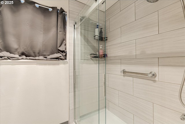 bathroom featuring a shower with shower door