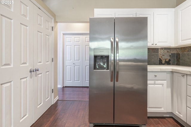 kitchen featuring stainless steel fridge with ice dispenser, dark wood-style floors, white cabinets, light countertops, and tasteful backsplash