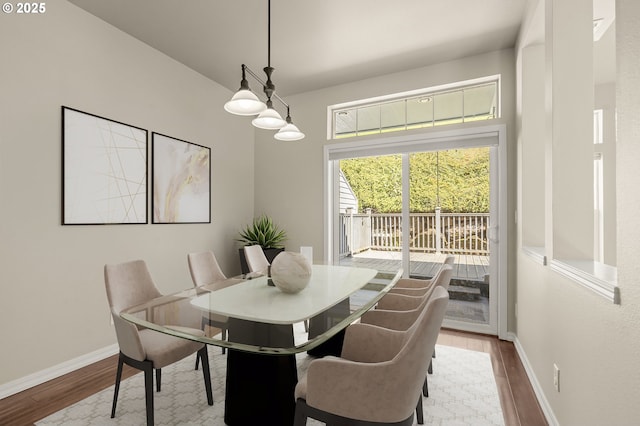 dining area featuring wood finished floors and baseboards